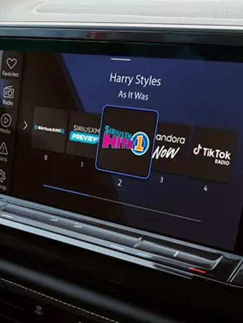 View of the Volkswagen in-vehicle infotainment screen showing the current radio station.