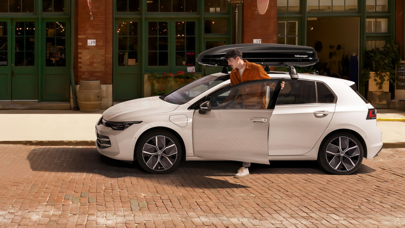 Man gets into VW Golf with roof box