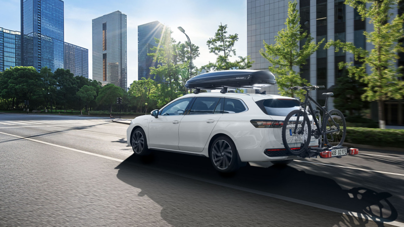 VW Passat model equipped with roof box and bicycle carrier by VW Accessories