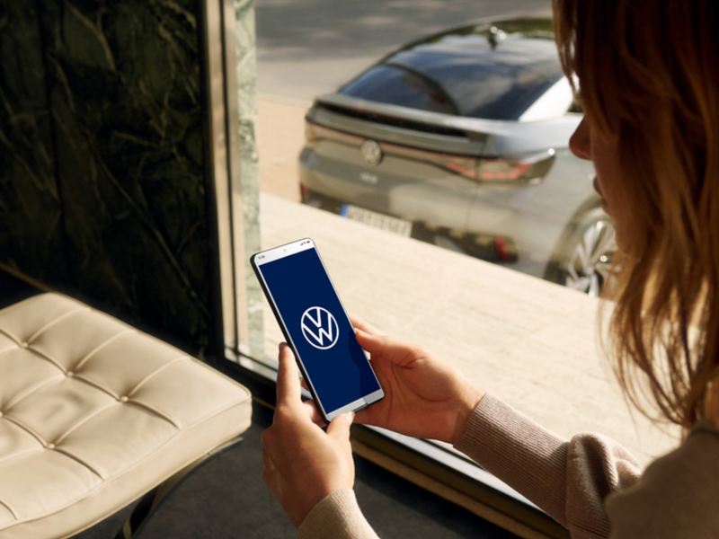 Woman using her myVW mobile app.