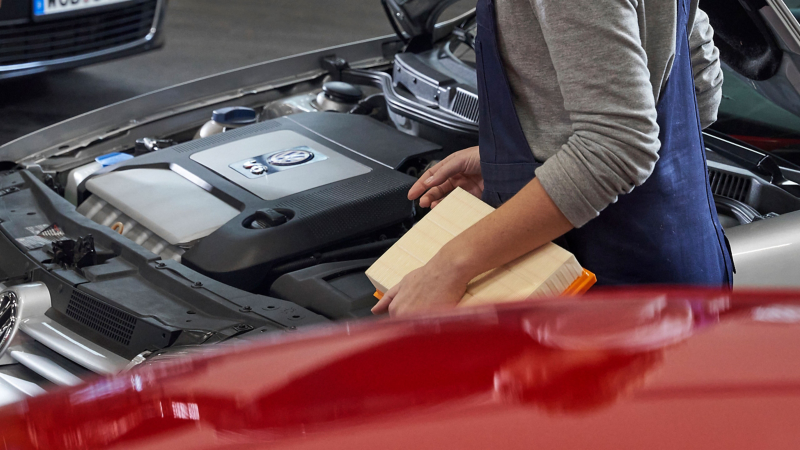 Mechanic replacing filter in Volkswagen car