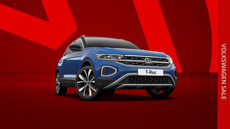 A blue T-Roc front view from low angle on a red background