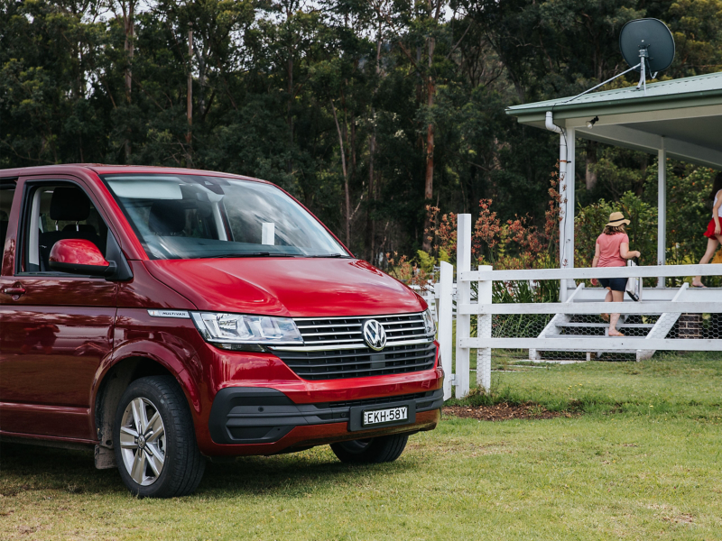 Red campervan parked on grass