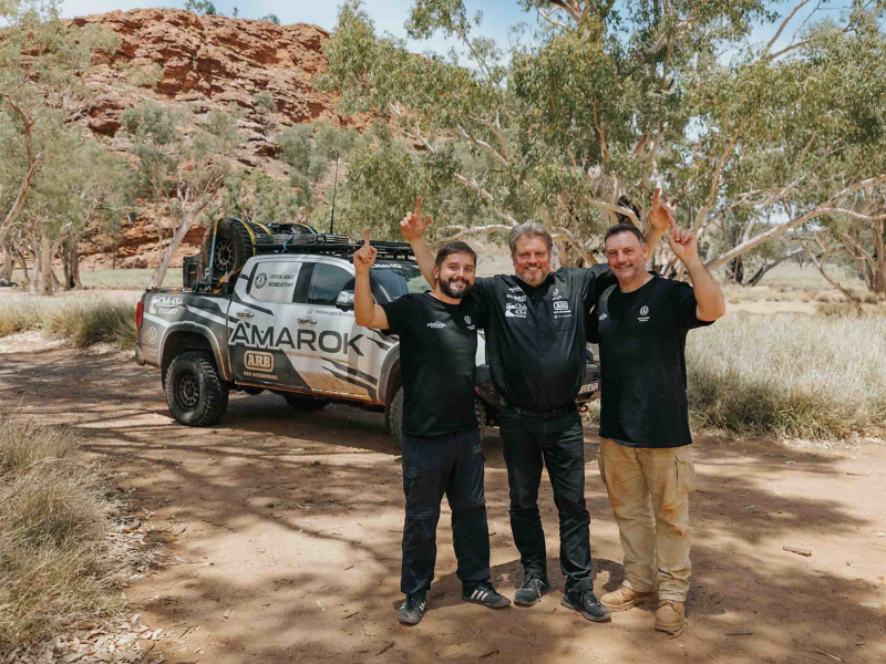 VW driving team in front of Amarok in the desert