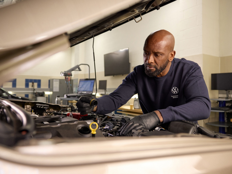 A VW service expert checking tyres.