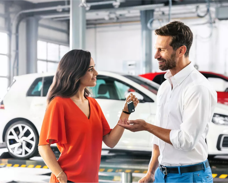 Man and woman scheduling service in VW dealership,