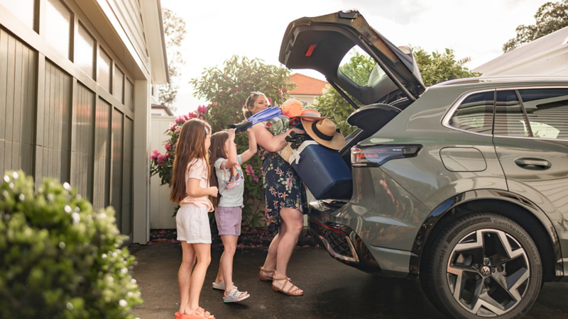 Busy mum packing boot of car