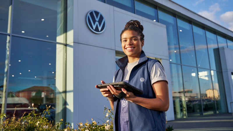 Une représentante du service à la clientèle VW regardant une tablette