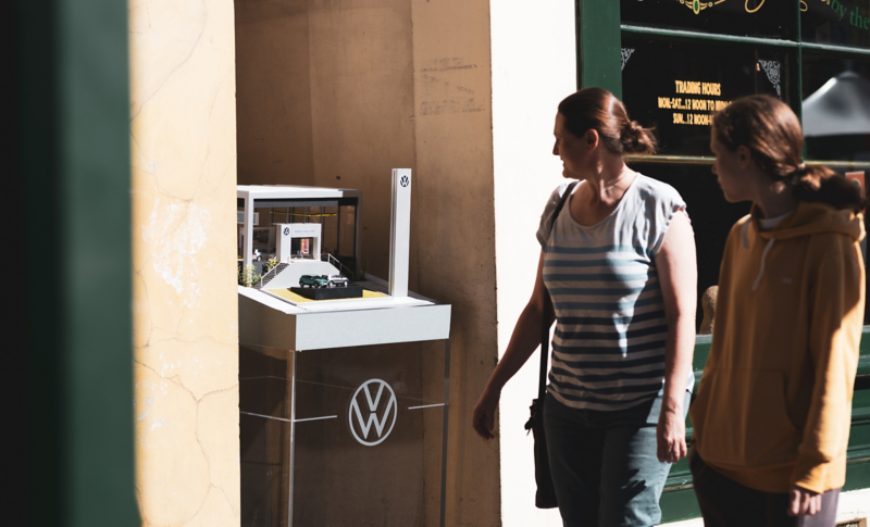 Two people looking at world's smallest dealership model