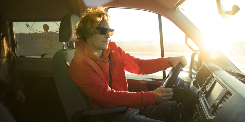 A person sitting at the steering wheel of a Grand California.