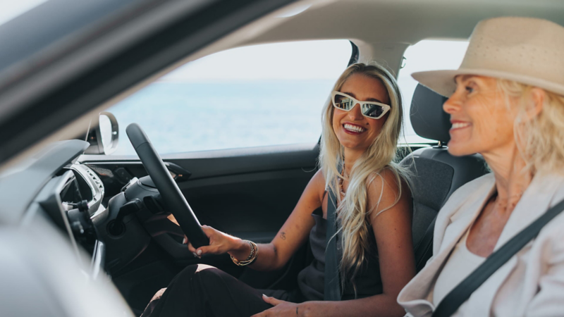 Two people in sat in the T-Cross smiling