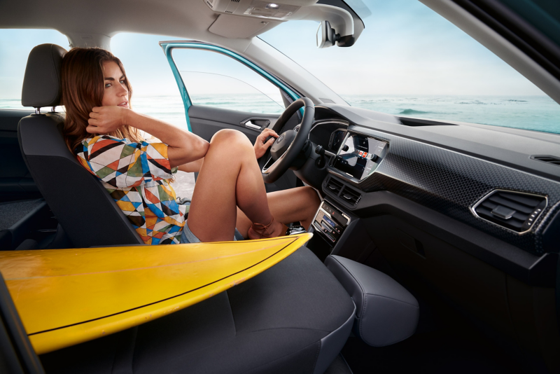 Women sat in VW car by the ocean