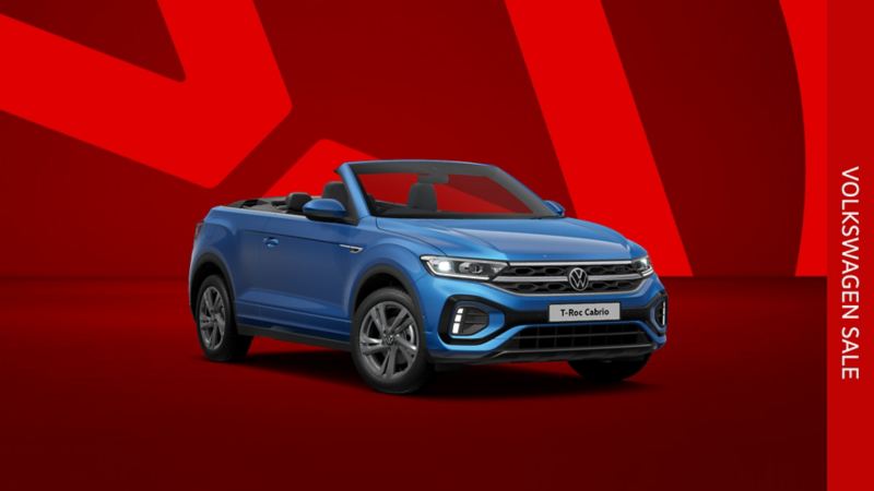 A blue T-Roc Cabriolet front view from low angle on a red background