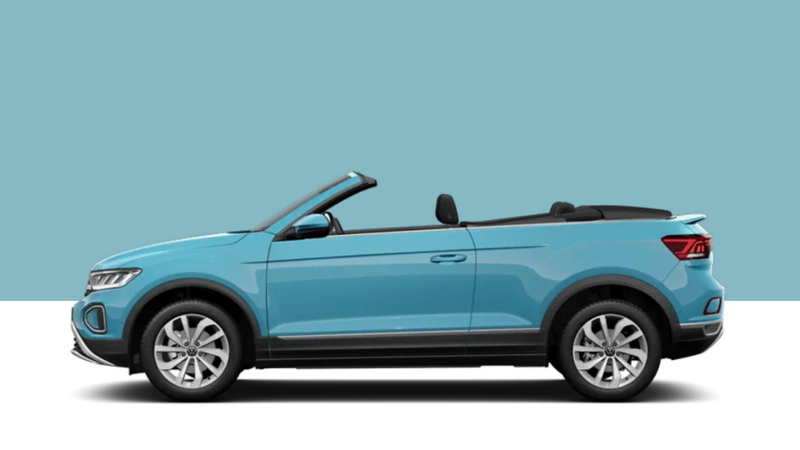 Side view of a red VW T-Roc on a light green background