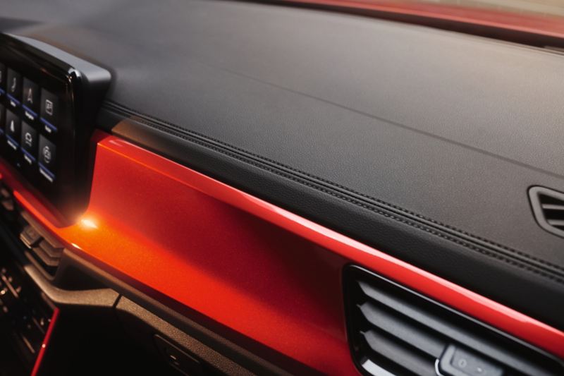 Detail of the decorative seams in the cockpit of the VW T-Roc Cabriolet with red decor.