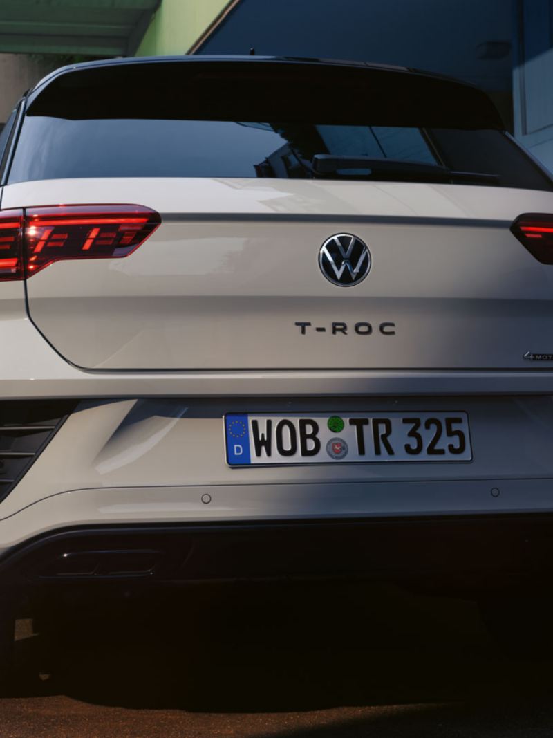 Rear view of a grey VW T-Roc, parked at the roadside