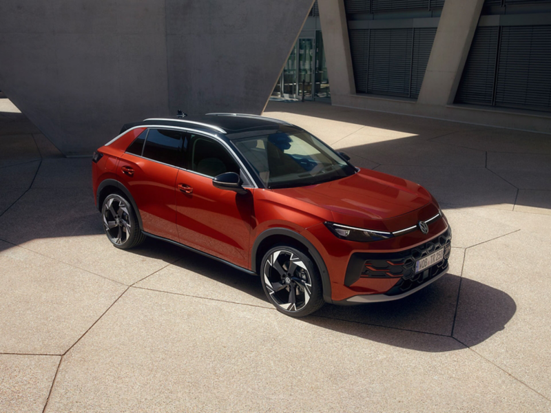 A red T-Roc parked in front of a building