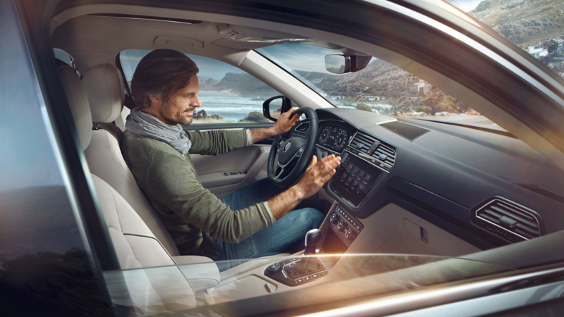 Man sitting inside of a VW Tiguan Allspace, interior