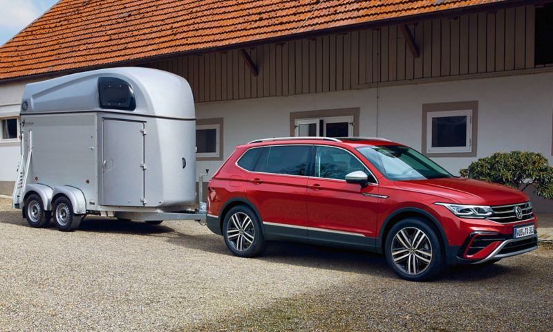 Red Tiguan Elegance with trailer on a pony farm.