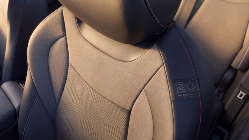 Detail view of the Edition 20 badge on the side of a front seat of a Tiguan Edition 20.