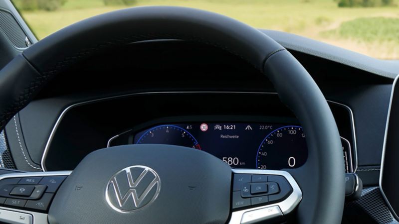 Detailed view of the cockpit of a VW T-Cross behind the steering wheel. 