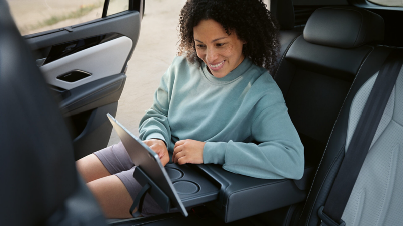 a woman sitting in the front seat of a new Tayron