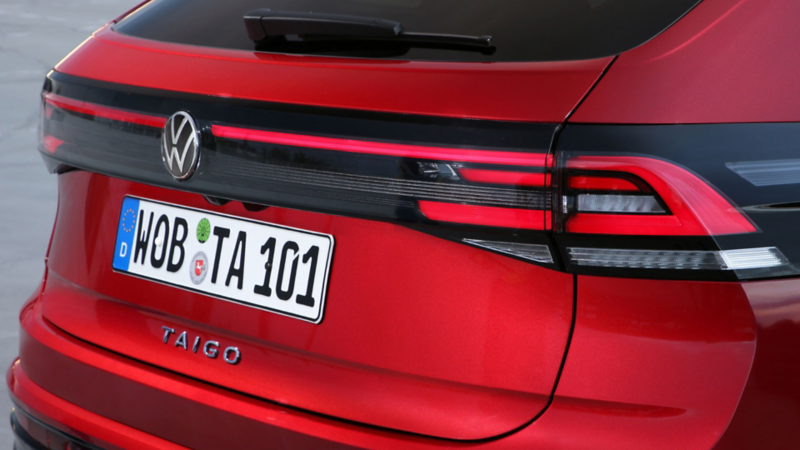 Side view of a moving white VW Golf eHybrid.