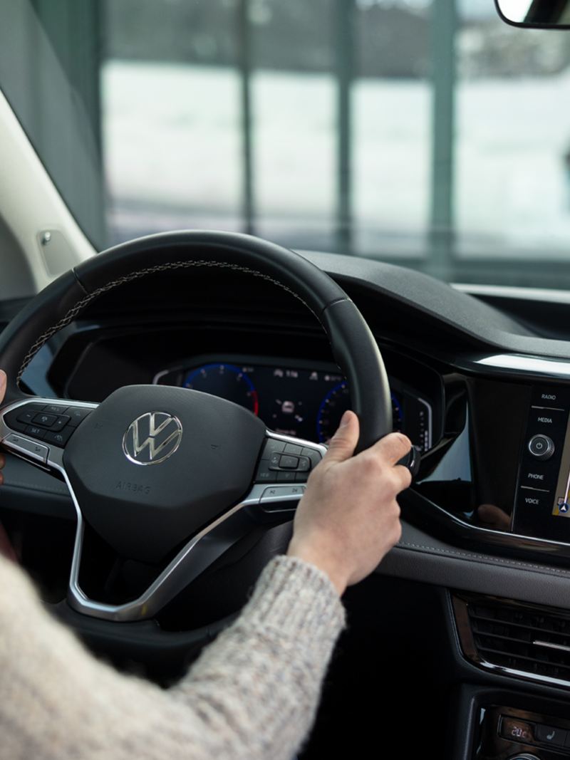 A woman driving the 2024 Volkswagen Taos