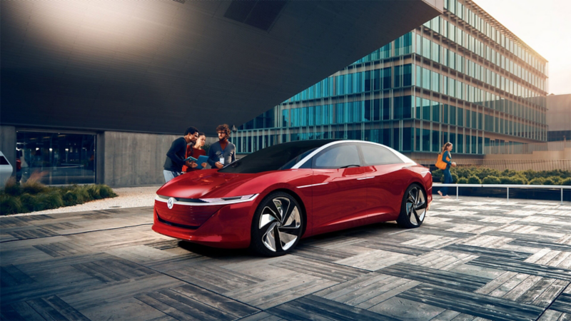A Volkswagen ID. Is parked in front of a building