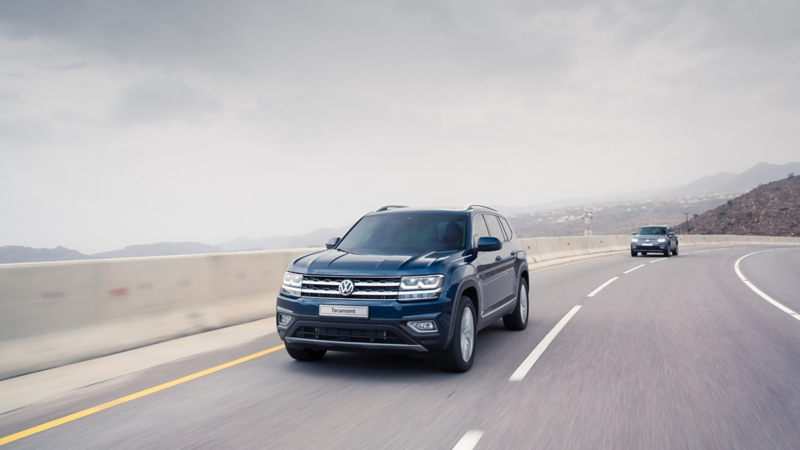 The Volkswagen Teramont driving around a mountain