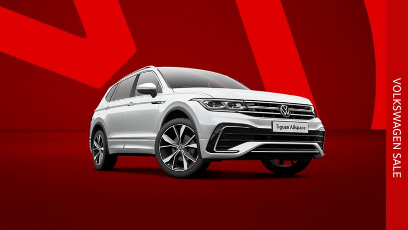 A silver Tiguan Allspace front view from low angle on a red background