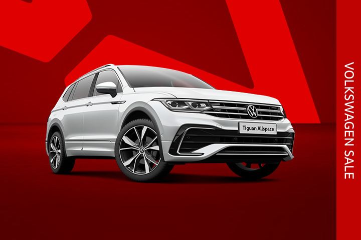 A silver Tiguan Allspace front view from low angle on a red background