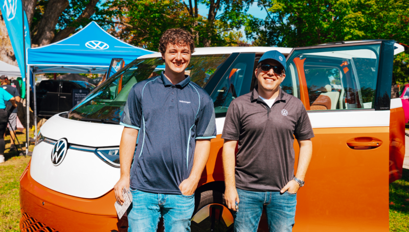 Two Volkswagen fans posing in front of the ID. Buzz