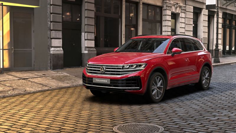 a red Touareg parked in a city