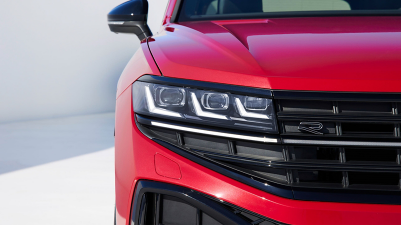 View of the rear of the VW Touareg R-Line with LED tail light clusters, light strip and illuminated VW logo.
