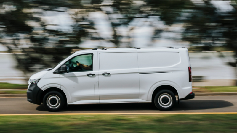 Volkswagen Transporter driving past some greenery
