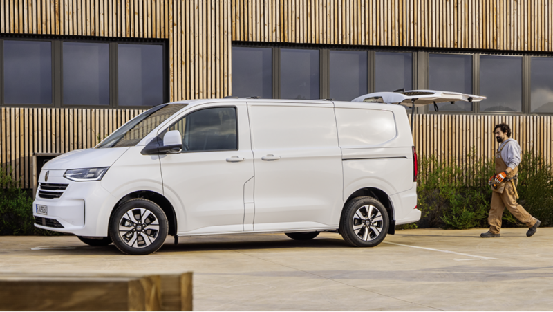 Volkswagen Transporter van which is parked outside a warehouse.
