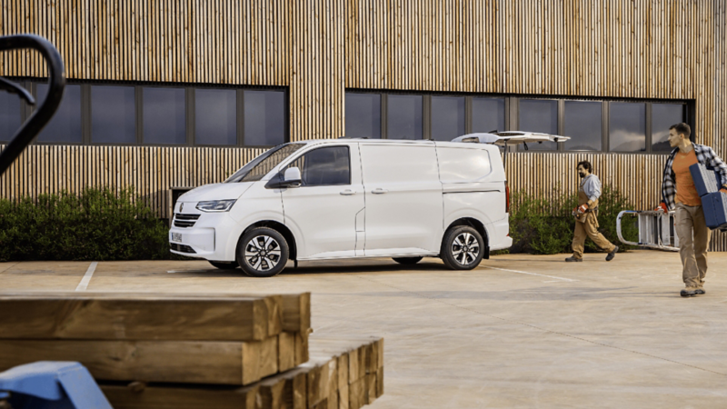 Woman loading boxes into Volkswagen Transporter