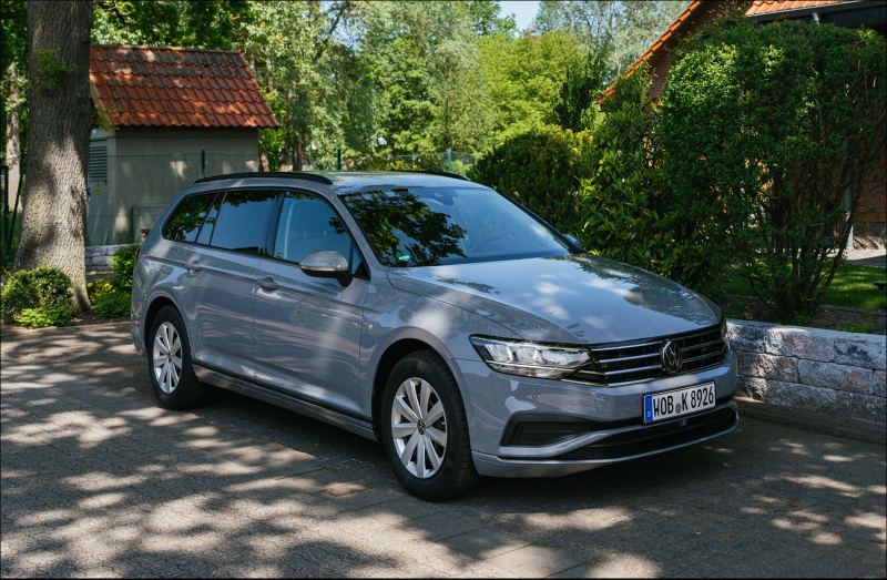 Silver Volkswagen estate car parked on a leafy driveway