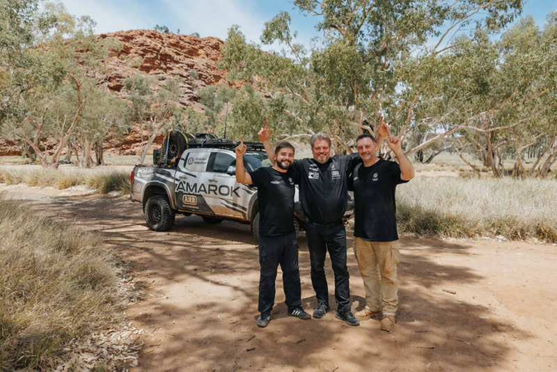 Amarok driving team stood in front of the Ute