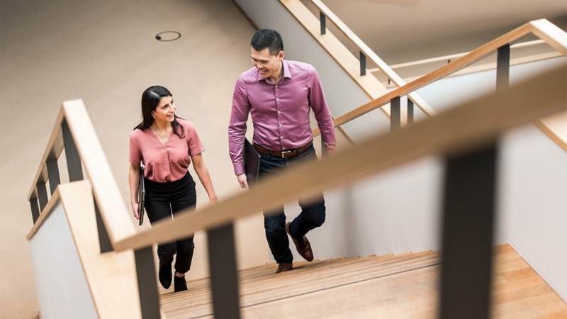 A woman and a man in conversation on the stairs