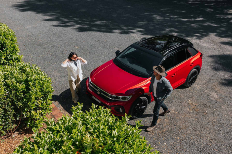 Couple exiting their red T-Roc