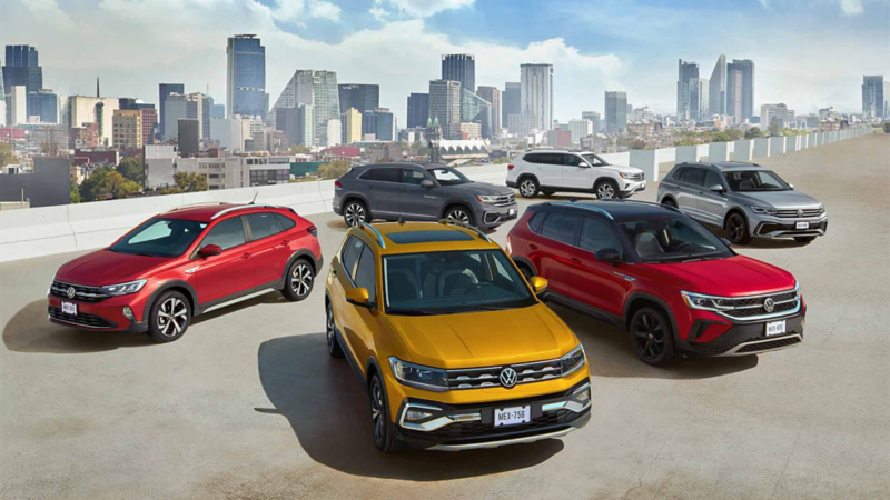 T Cross 2022 en color amarillo cúrcuma sobresale de SUVs 2022 de Volkswagen, ubicadas en azotea de edificio.