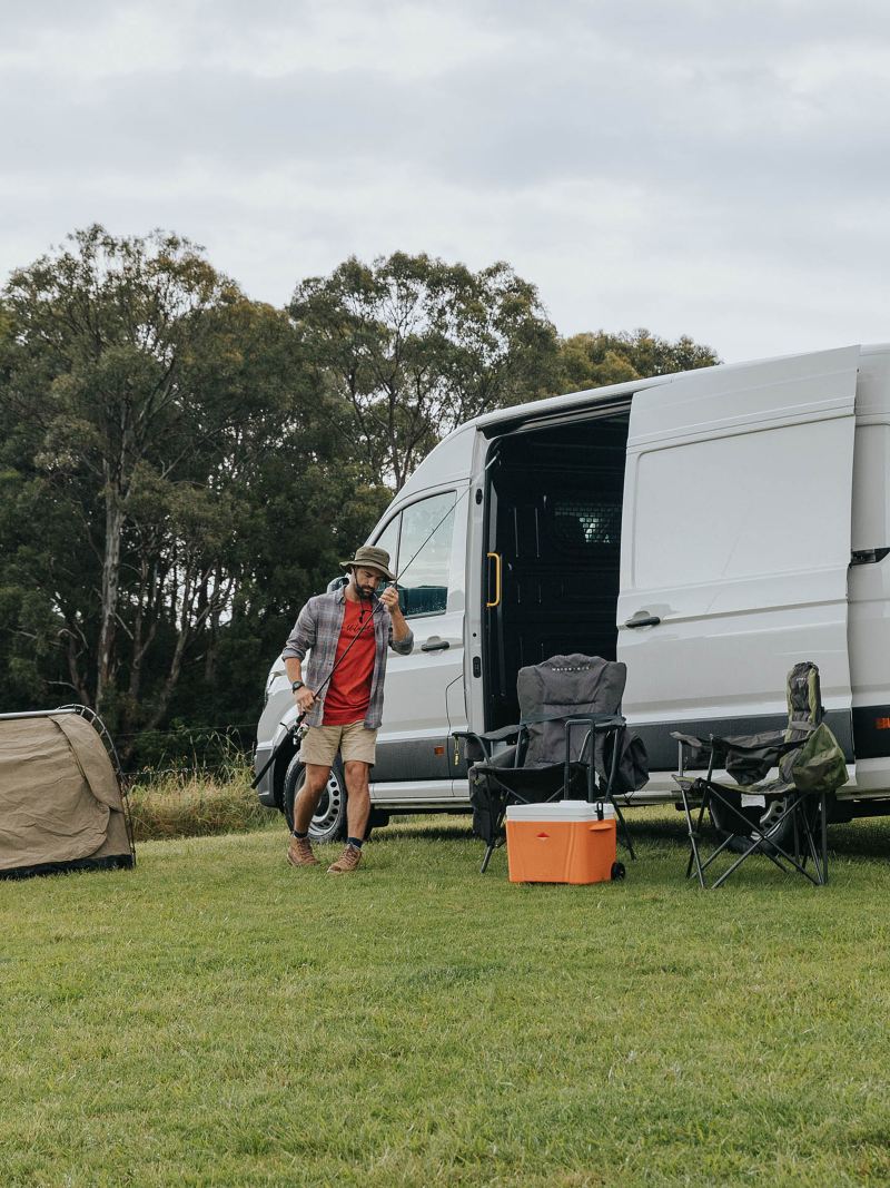 Volkswagen Crafter van parked with camping setup.