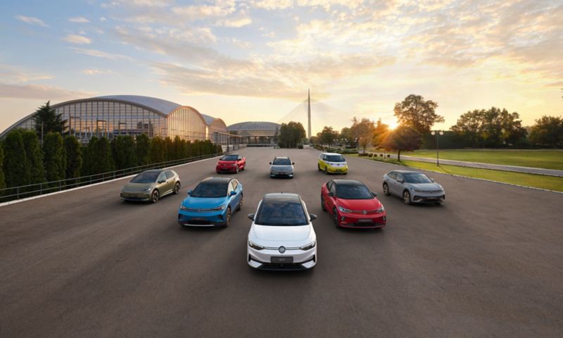 A fleet of VW cars driving towards the camera on an open road