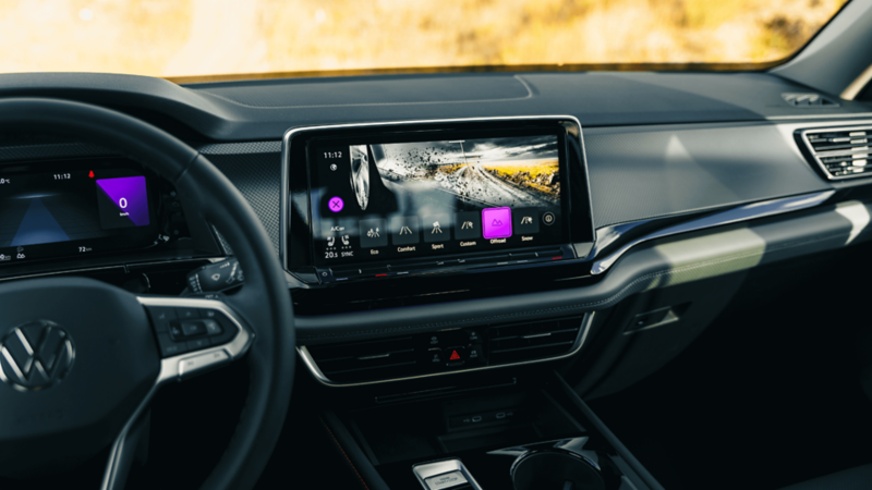"Interior view of the Volkswagen Atlas showing the digital touchscreen with updated drive mode selection interface, including terrain, sport, and eco options. "