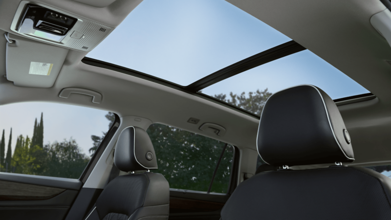 Interior view of the Volkswagen Atlas highlighting the panoramic sunroof, with natural light coming through the open glass roof.
