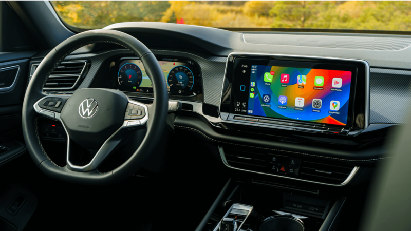 Collage of five images showcasing the Volkswagen Atlas Cross Sport, including front and rear exterior views, close-up of the wheel, panoramic sunroof, and interior dashboard with infotainment system.