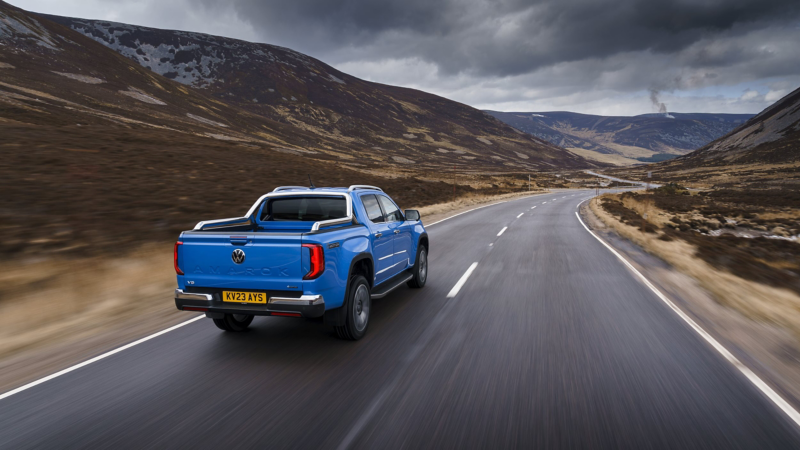 A blue VW Amarok driving down a road. 