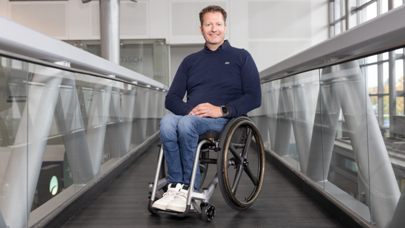 Gerd Schmees sitzt im Rollstuhl auf einem Gang.